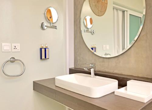 卡拉奇Ambiance Boutique Art Hotel Karachi的浴室设有白色水槽和镜子
