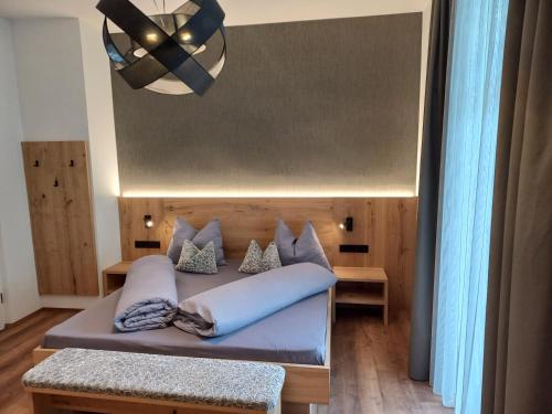 梅拉诺Appartements König的一间卧室配有一张床和一个吊灯
