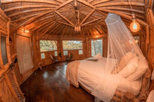 科科尔纳Ecohotel Tierra de Agua的一间卧室,配有一张带面纱的床