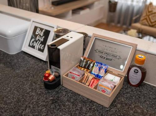 约翰内斯堡Nal'enzo Luxe Stays的厨房柜台,配有一盒食物和咖啡壶