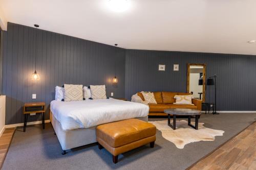 蒙特维尔Luxury Spa Retreat with Ocean and Hinterland Views的一间卧室配有一张大床和一张沙发