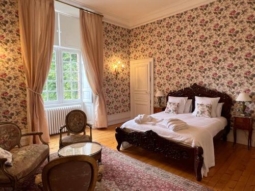 勒芒24H LE MANS Château de Lauresse chambres d'hôtes Luxe的一间卧室配有一张床和花卉壁纸