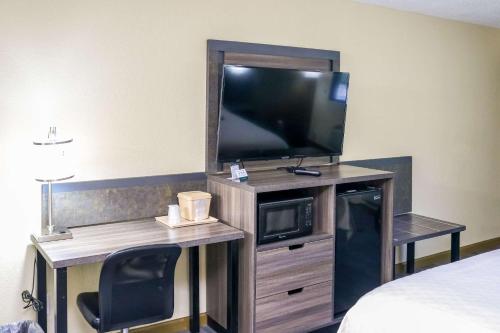 凤凰城Rodeway Inn的酒店客房设有电视和带椅子的书桌