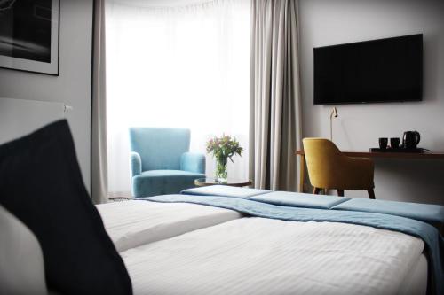 波兹南Platinum Residence Boutique的酒店客房设有两张床和电视。