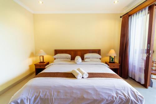 坎古Sakura Guest House的一间卧室配有一张大床和毛巾