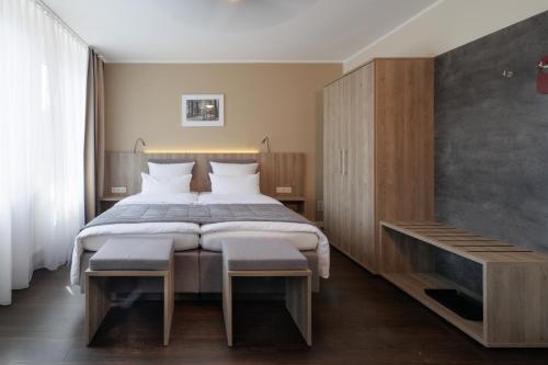 明斯特Hotel Jellentrup - Adults Only的一间卧室配有一张大床和一个木制橱柜