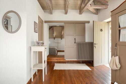 帕皮康安佛拉格尼奥酒店的走廊设有白色墙壁、木地板和镜子