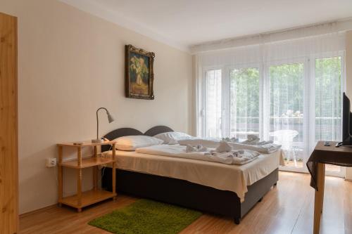 蒂豪尼Sylvia Ház的一间卧室配有一张床、一张书桌和一个窗户。