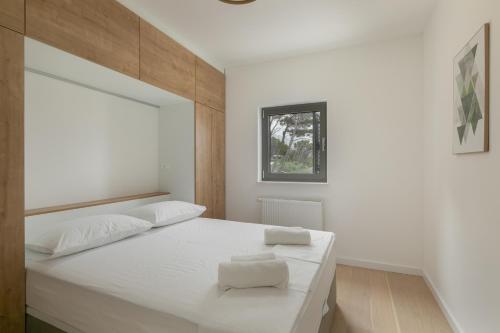 布雷拉Apartments with a swimming pool Brela, Makarska - 19345的卧室配有一张大白色床和窗户