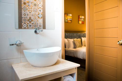 恩德培Hotel Horizon Entebbe的一间带白色水槽和床的浴室