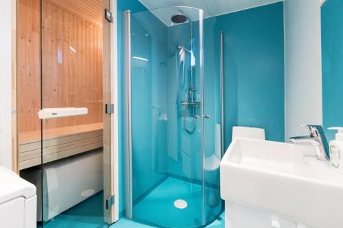 布鲁克斯瓦拉那Bruksvallarna - Modern fjällstuga med panoramautsikt och WiFi的蓝色的浴室设有淋浴和水槽
