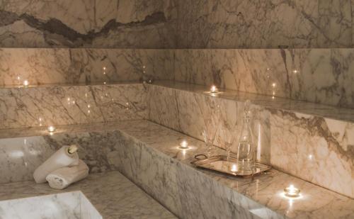 埃斯特角城Yoo Punta Del Este的浴室设有大理石浴缸,上面有蜡烛