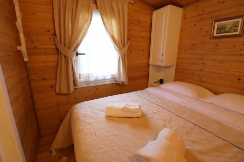 奥拉迪亚Căsuța din vale的一间卧室配有一张床,上面有两条毛巾