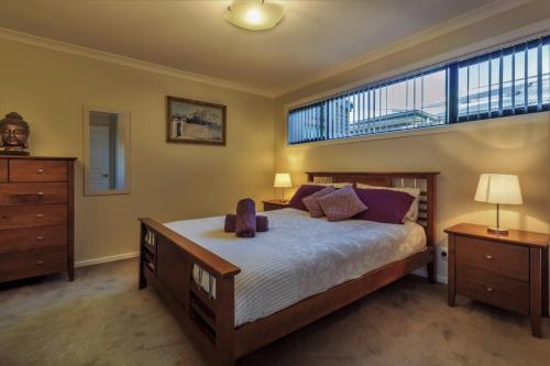 托基Torquay Homestay Guesthouse的一间卧室设有一张大床和一个大窗户