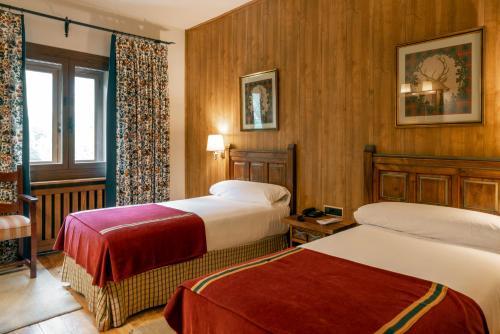 伊斯皮尔巴贝尔萨帕拉多尔酒店的酒店客房设有两张床和窗户。