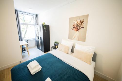 鹿特丹Admiringly 1 Bedroom Serviced Apartment 56m2 -NB306A-的一间卧室配有一张带蓝色毯子的大床