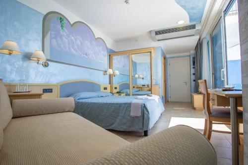 利多迪耶索罗宇宙酒店的一间卧室配有一张床、一张桌子和一张书桌