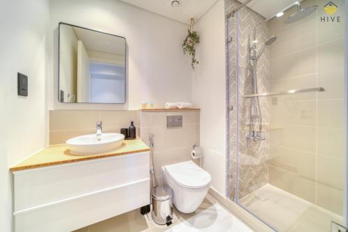 迪拜Lovely 1 Bedroom Apartment in Collective 2.0的一间带水槽、卫生间和淋浴的浴室