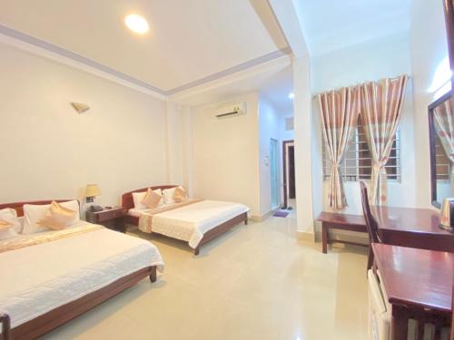 河仙都洪2号酒店的一间卧室设有两张床、一张桌子和一个窗口。