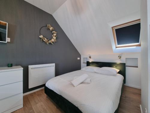 布吕兹Le Cœur d’Artichaut by Madame Conciergerie的卧室设有一张白色大床和一扇窗户。