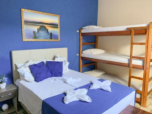 卡波布里奥Pousada do Luar Cabo Frio的一间卧室设有两张双层床和蓝色的墙壁