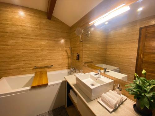 莫尔吉姆Sandbanks Beach Villas, Morjim的浴室配有盥洗盆和浴缸。