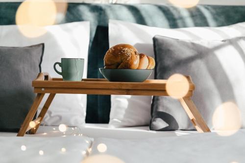 滨湖新锡德尔达斯斯塔德豪斯酒店的床上的面包盘和咖啡