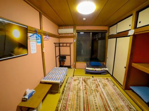 富士宫市Guesthouse TOKIWA - Vacation STAY 43369v的一间设有两张长椅和一张地毯的房间