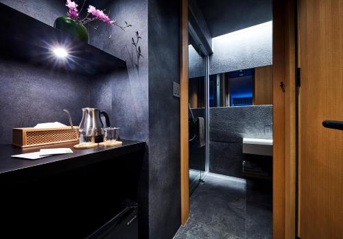 名古屋HOTEL和紡的浴室设有水槽和带镜子的台面