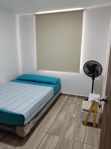圣希尔Hermoso y Cómodo Apartamento--Excelente Ubicación的一间卧室配有一张床和风扇