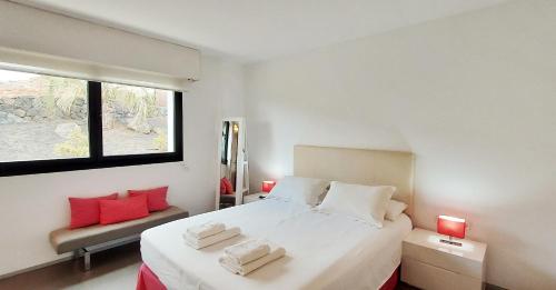 维拉韦德Luxury Villa Sand Volcano的卧室配有带红色枕头的大型白色床