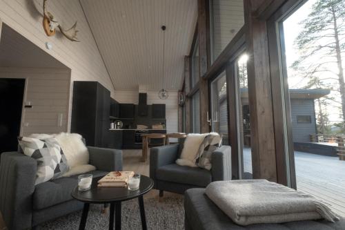 伊瓦洛Norlight Cottages Ivalo - Tuli的客厅配有两把椅子和一张桌子