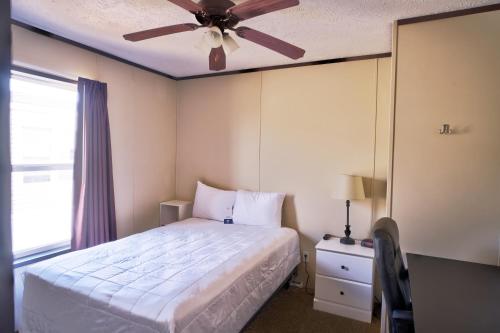 卡尔斯巴德Ellipse Global Lodge的一间卧室配有一张床和吊扇