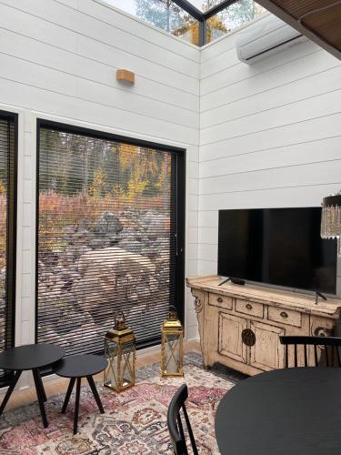 锡尔卡Glass Ceiling Suite Kipinä的客厅设有大窗户和平面电视。