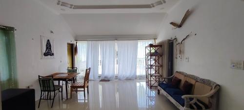 西奥利姆J-House, spacious apartments with balconies, Thalassa 1min away的客厅配有蓝色的沙发和桌子