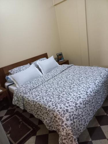 达喀尔Appartement sympathique Jules Ferry.的一间卧室配有一张带黑白色棉被的床