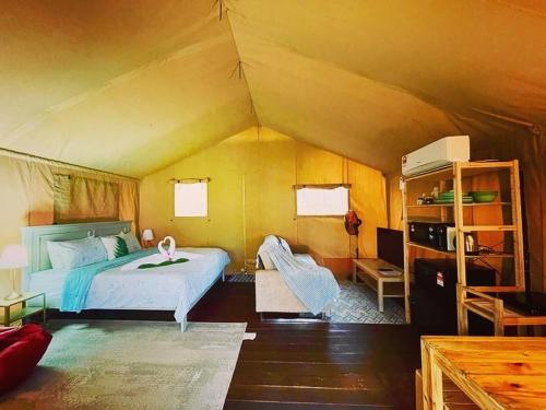 佩纳利克村Rembulan Escape - Beachfront safari tent的帐篷内一间卧室,配有一张床