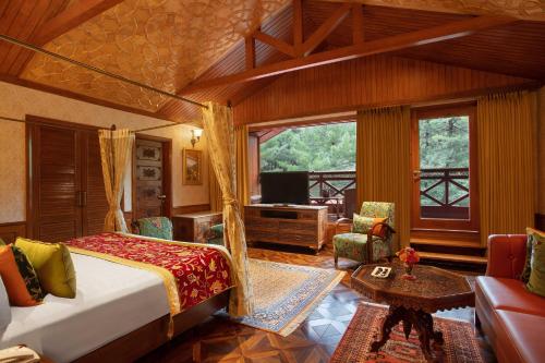 帕哈尔加姆Welcomhotel by ITC Hotels, Pine N Peak, Pahalgam的一间卧室配有一张床,并在一间客房内配有电视。