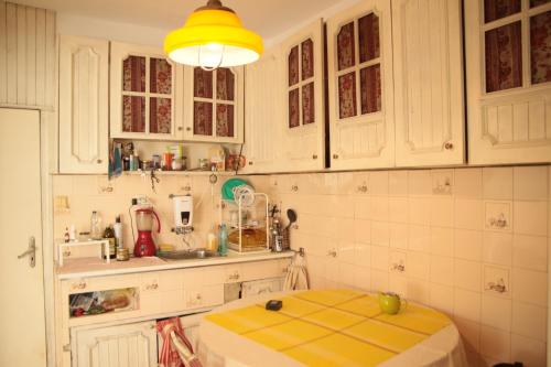瓦尔纳Elie's Home的厨房配有白色橱柜和黄色台面