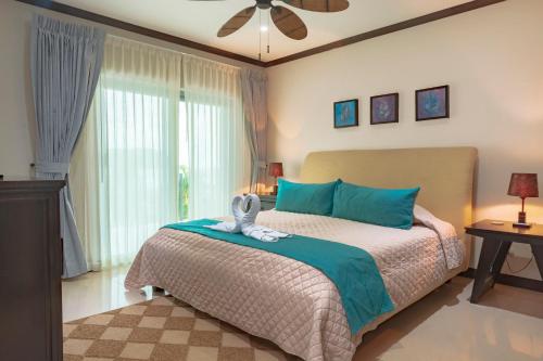 雅科Diamante del Sol Ocean front, Jaco Paradise CR的一间卧室配有一张床和吊扇