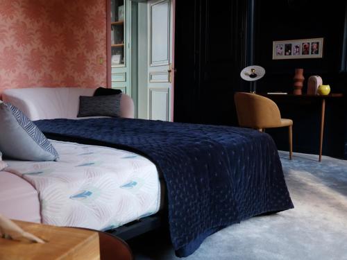Saint-Martin-lez-TatinghemMille et une feuilles的一间卧室配有一张带蓝色毯子的床