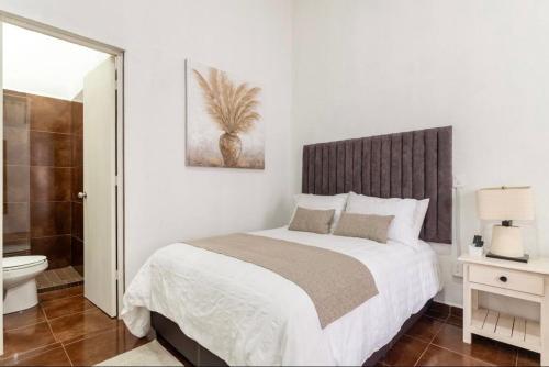 特科早特拉Suite Copal的一间白色卧室,配有床和一间浴室