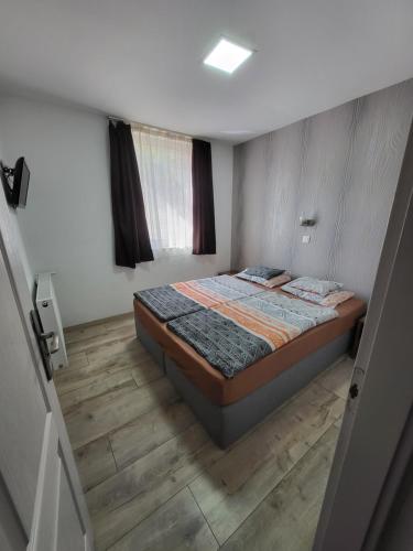 索普隆索普隆玛丽卡公寓的一间卧室配有一张床,铺有木地板
