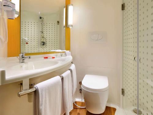 库塔巴厘岛库塔宜必思酒店的一间带水槽、卫生间和镜子的浴室
