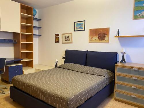 格罗塞托港Ville sul Mare的一间卧室配有一张床、一张桌子和书架