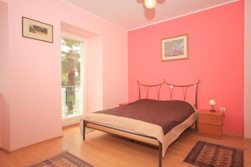 伊齐齐Apartments by the sea Ika, Opatija - 3426的粉红色的卧室设有床和窗户