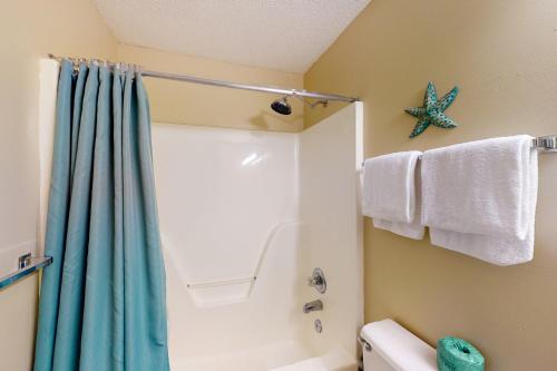 佩尔迪多基Grand Caribbean West 0107的带淋浴和蓝色浴帘的浴室