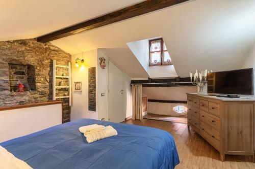 切尔诺比奥Casa al Lago di Como in Riva Cernobbio的一间卧室配有蓝色的床和一台平面电视