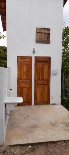 韦尔卡鲍Cantinho HAKUNA MATATA-Vale do Capão a 5 min da Vila的房屋设有2扇木门和卫生间