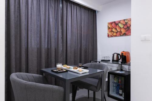 巴勒莫Suite Palermo Apartment的配有桌椅和窗帘的房间